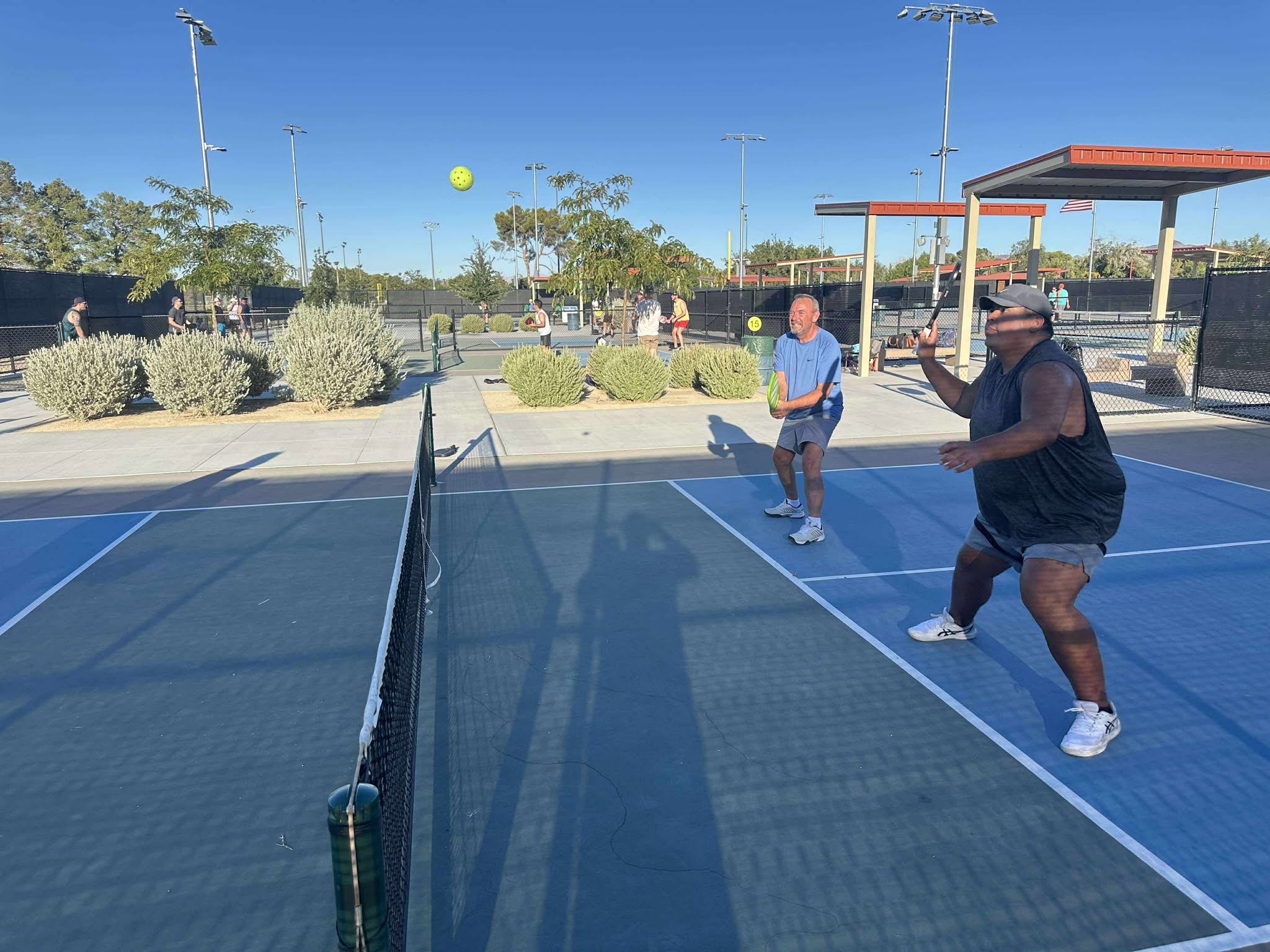 Players laughing and playing pickleball